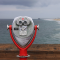 Silver Looking glass on red stand, overlooking the beach