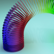 colorful slinky toy arching across aqua background