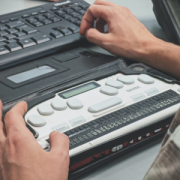 hands working on an adaptive keyboard