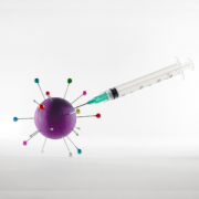 syringe injecting stylized covid-19 virus