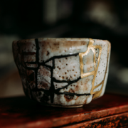 A Kintsugi pottery cup that's been broken and repaired with gold
