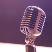 photo of old fashioned stand microphone on purple background