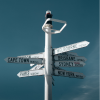 White world cities signpost on blue sky background